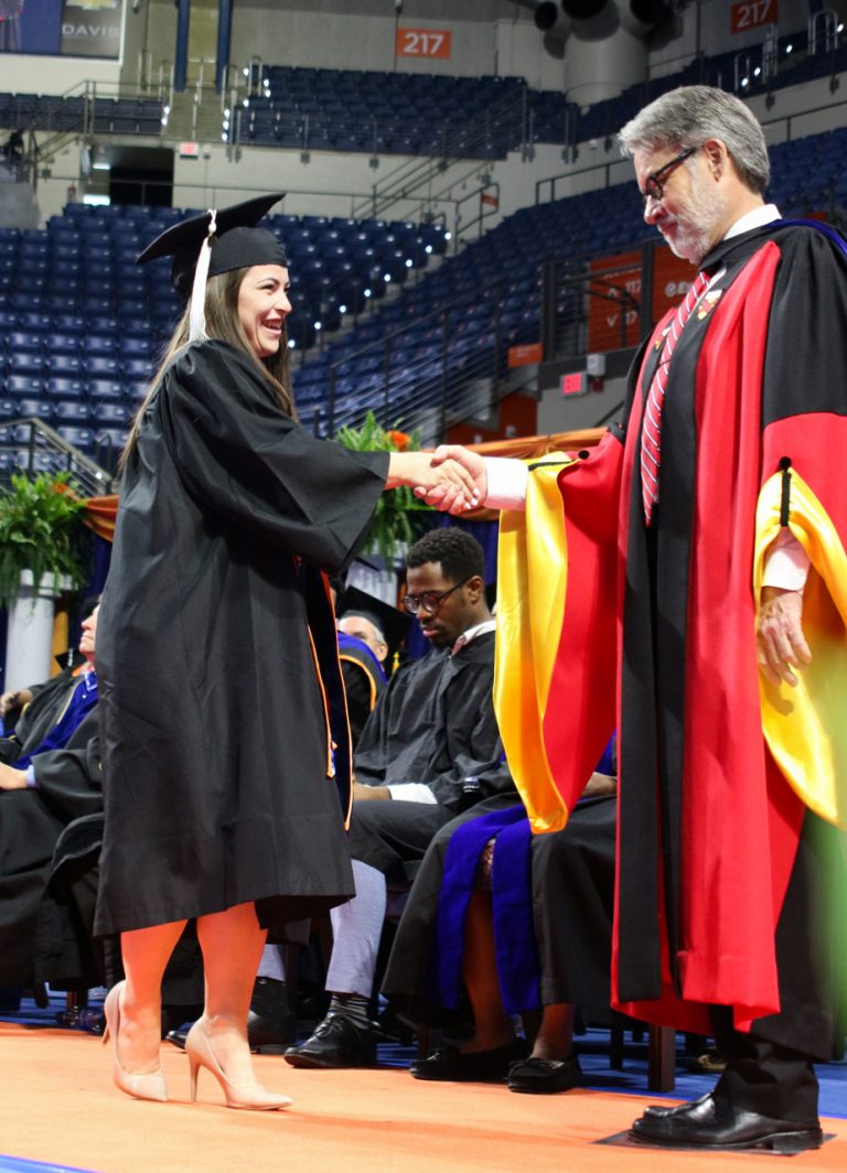 Graduating student shaking hands with dean