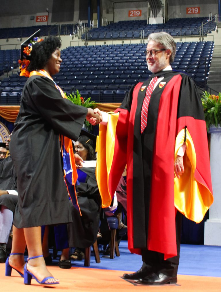 Graduating student shaking hands with Dave Richardson