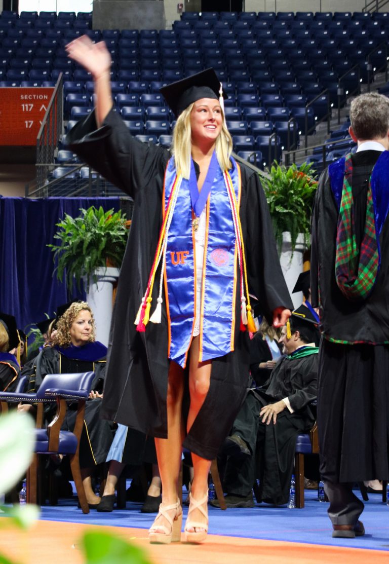 Graduating student with hand in the air