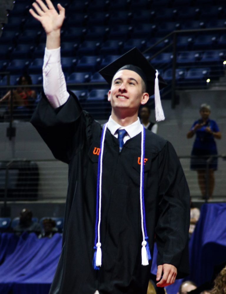 Graduating student with arm in the air