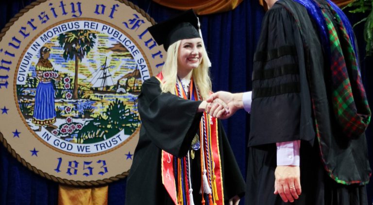 Graduating student shaking hands