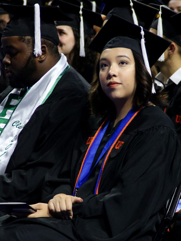 Graduating student listening to speaker