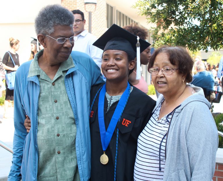 Graduating student poses with family
