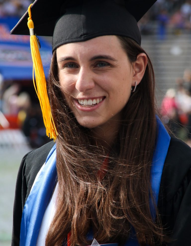 Graduating student smiling at the camera