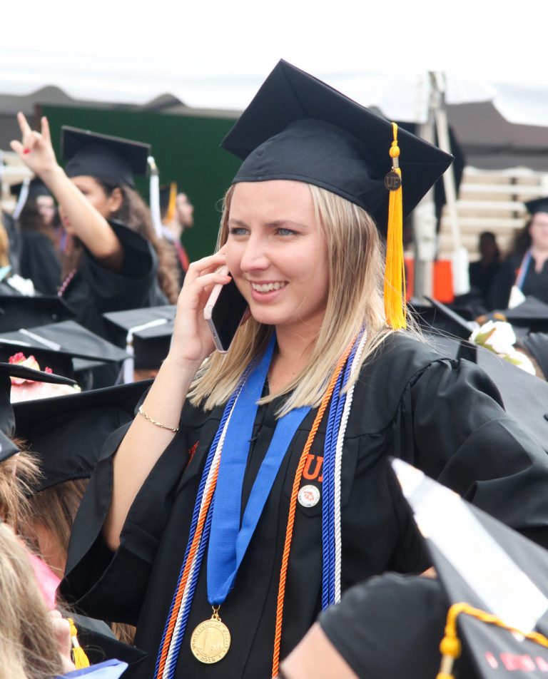 Graduating student on the phone smiling