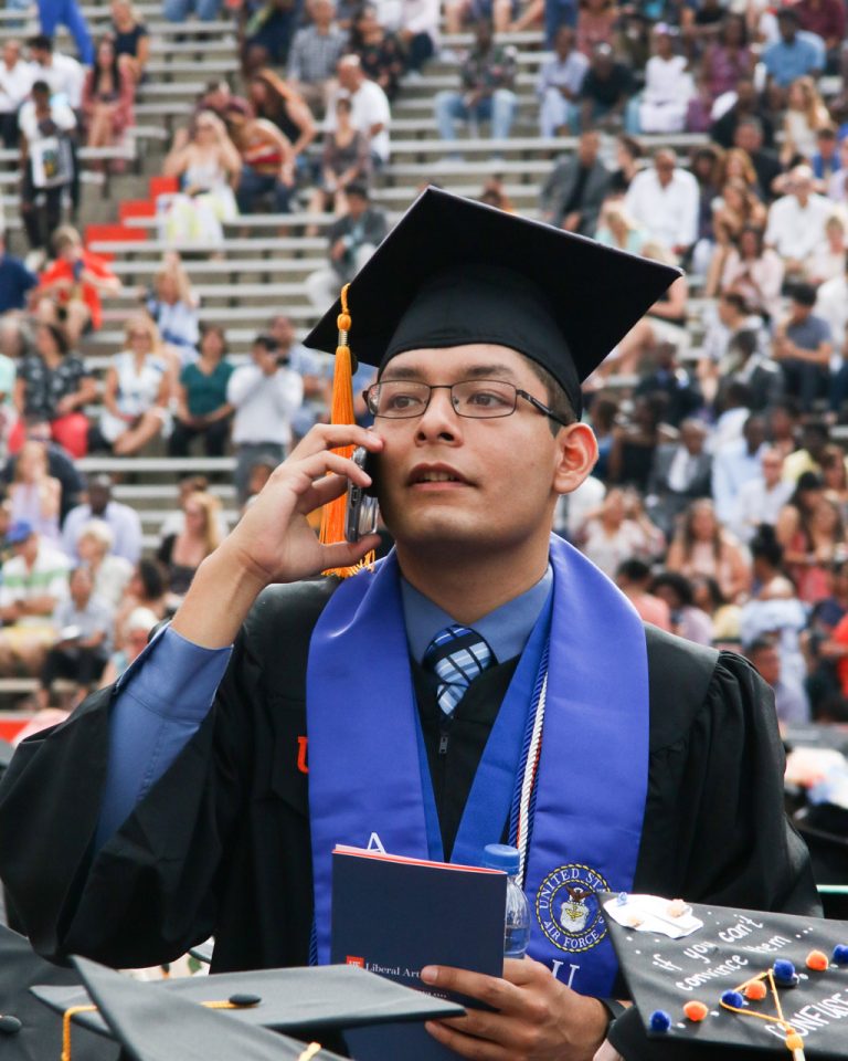 Graduating student on the phone looking for someone