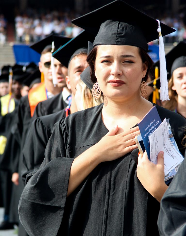 Graduate student with hand over heart