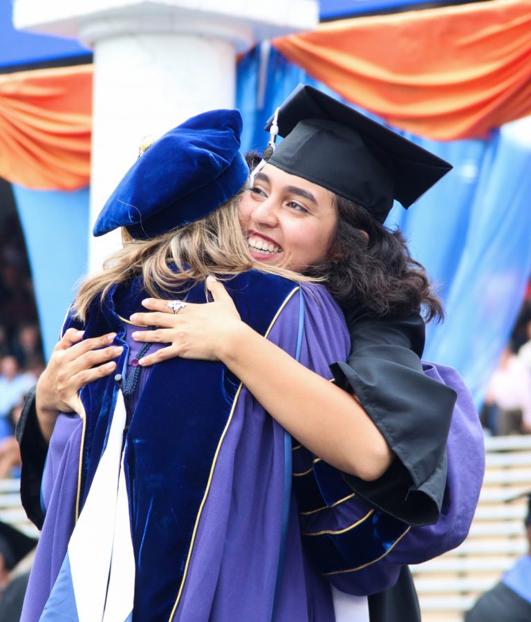 Graduating student hugging someone