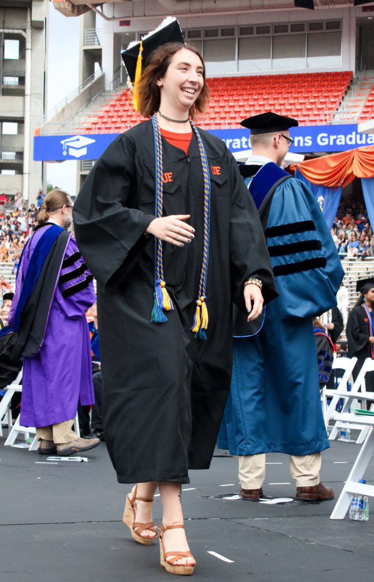 Graduate student walking on stage